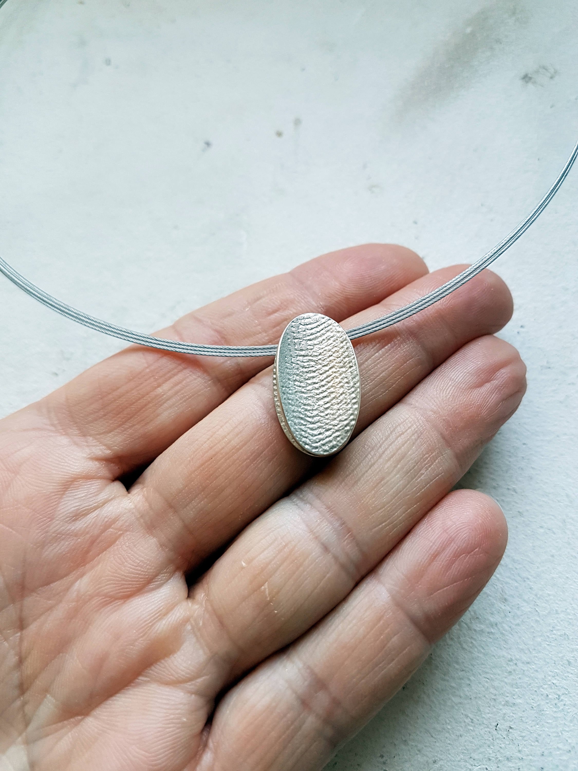 Silver oval linen textured pendant on spiral choker - Image 4